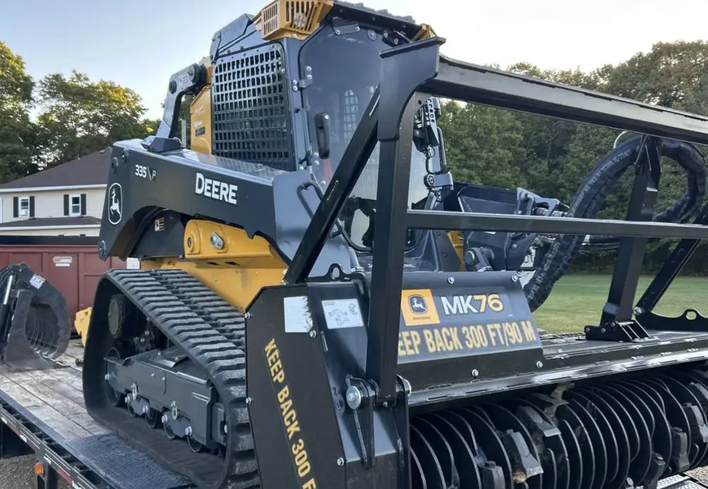 John Deere 333G with the MK76 mulching head mounted, loaded for transport
