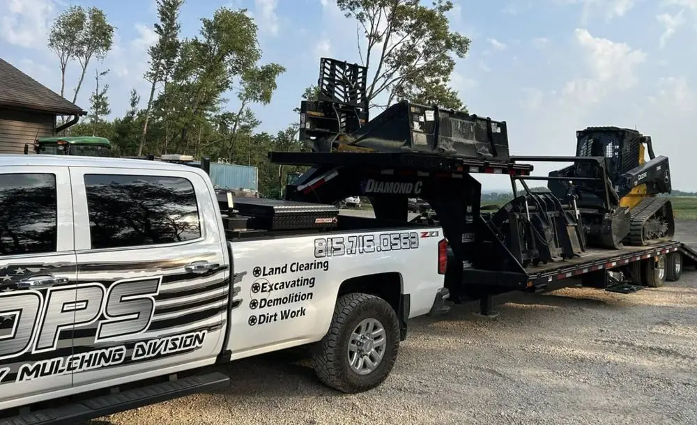 OPS truck and trailer loaded with the tracked skid steer and mulching head